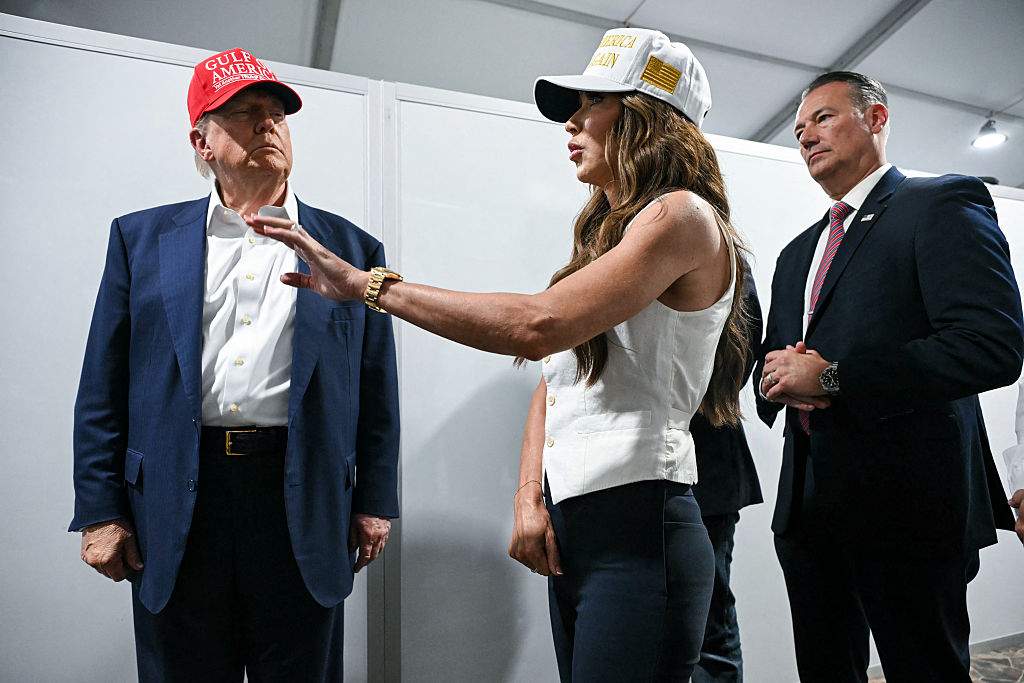 U.S. President President Donald Trump speaks with Secretary of Homeland Security Kristi Noem as they tour a migrant detention center, dubbed "Alligator Alcatraz," located at the site of the Dade-Collier Training and Transition Airport in Ochopee, Florida on July 1, 2025.