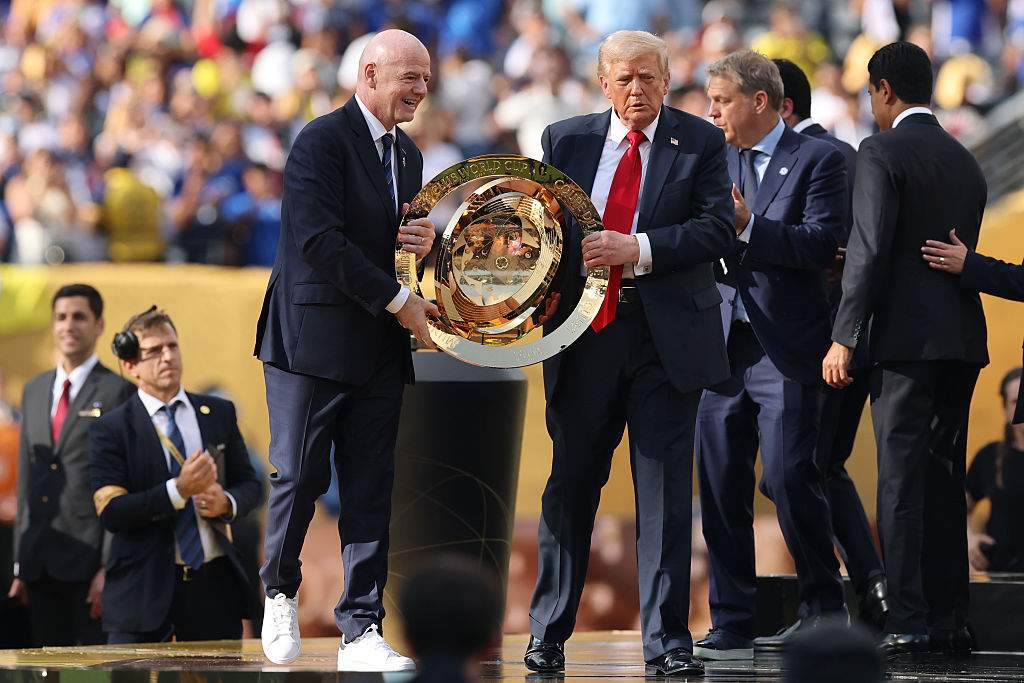 Gianni Infantino, president of FIFA, and U.S. President Donald Trump present the FIFA Club World Cup trophy during the FIFA Club World Cup 2025 final match between Chelsea FC and Paris Saint-Germain.