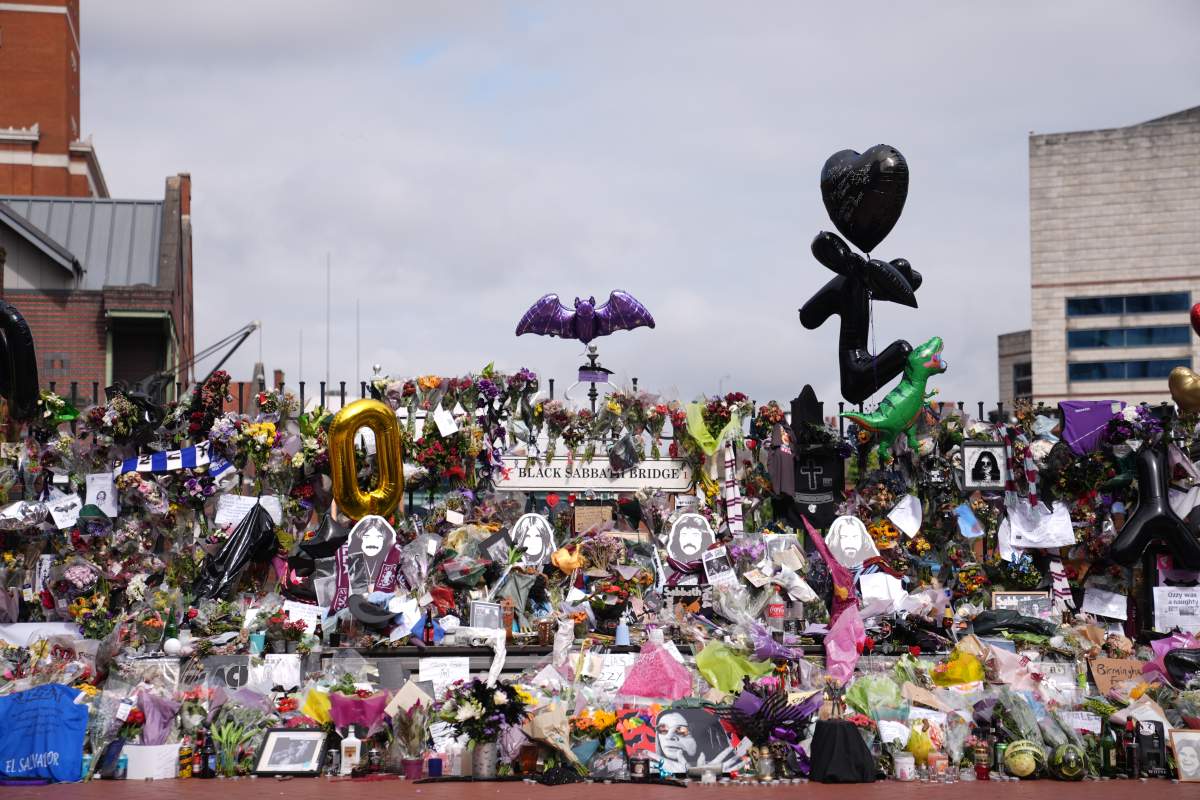 Floral tributes left at the Black Sabbath Bridge bench on Broad Street in Birmingham in memory of Black Sabbath frontman Ozzy Osbourne, ahead of his body being brought back to his home city for a procession following his death last week aged 76. Picture date: Wednesday July 30, 2025.