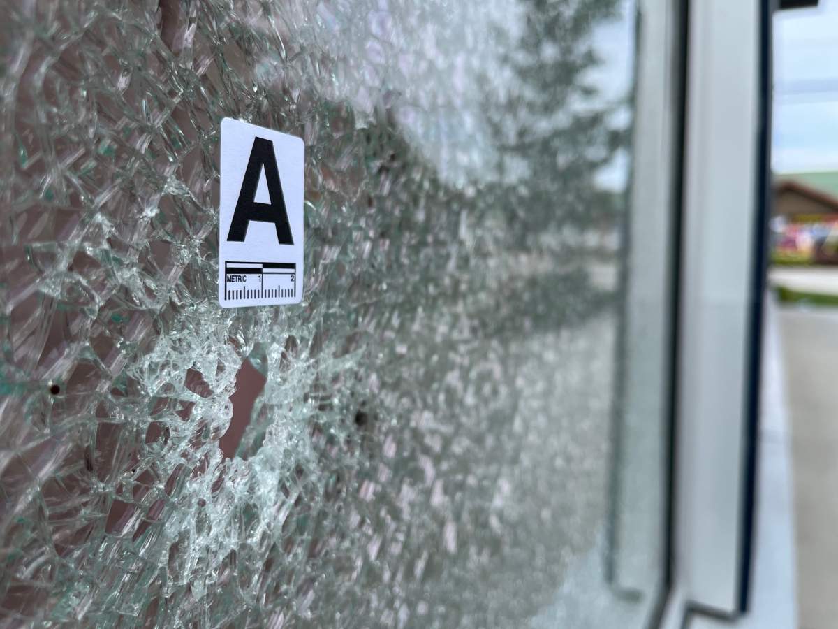 Bullet holes can be seen in the window of the cafe in Surrey.