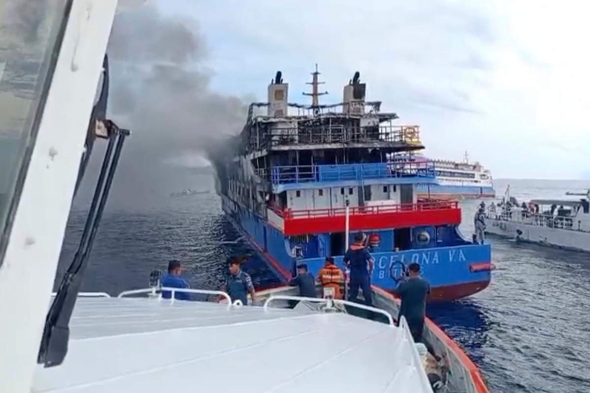In this photo made from video released by the Indonesian National Search and Rescue Agency (BASARNAS), rescue ship approach passenger ship KM Barcelona after it caught fire in the waters off Talise Island in North Sulawesi, Indonesia, Sunday, July 20, 2025.