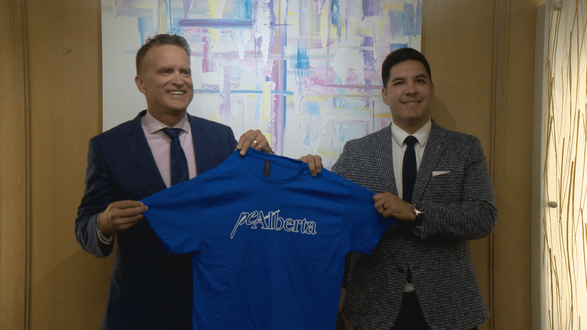 Independent MLA's Peter Guthrie and Scott Sinclair hold up a Progressive Conservative Party shirt as they announce plans to revive the Progressive Conservative party in Alberta.