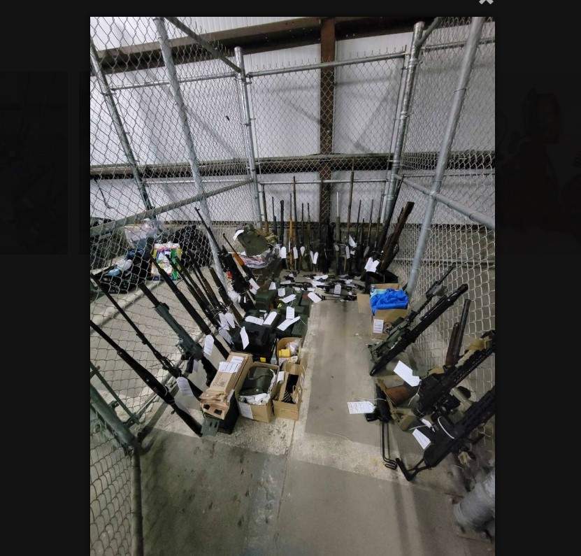 Photo of dozens of long gun weapons seized by police in January 2024 raids.