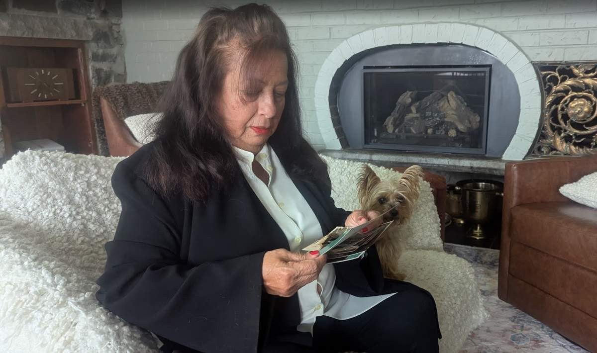Amria Estella Cano, a Mississauga, Ont. resident, looks at pictures of her daughter Paula Callejas, 45. Callejas has been detained by ICE since April.