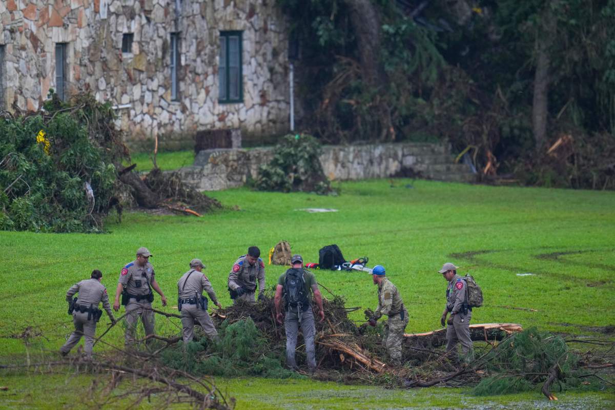 Officials search on the grounds of Camp Mystic along the banks of the Guadalupe River after a flash flood swept through the area Sunday, July 6, 2025, in Hunt, Texas.