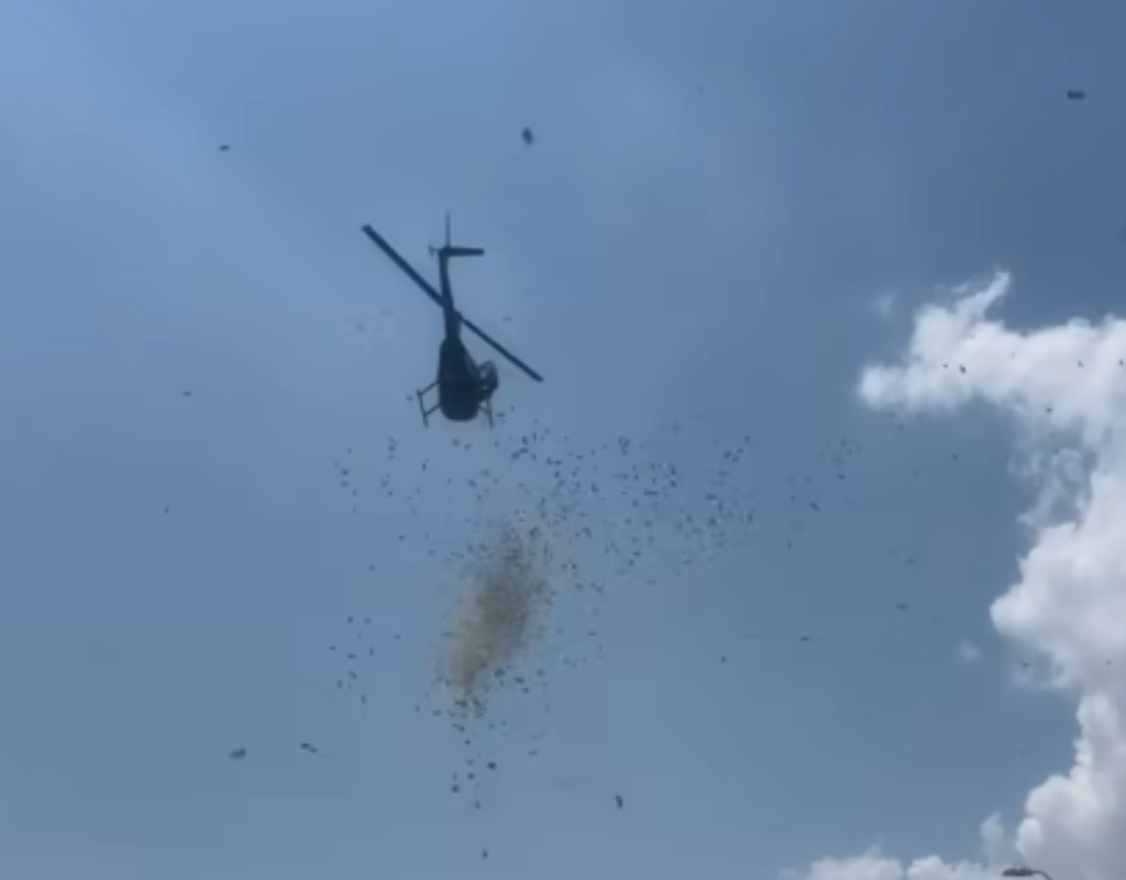 Money falls from a helicopter flying above Detroit, Michigan on June 27. The cash was sent by the family of a deceased local businessman whose dying wish was shower his community in acts of generosity.