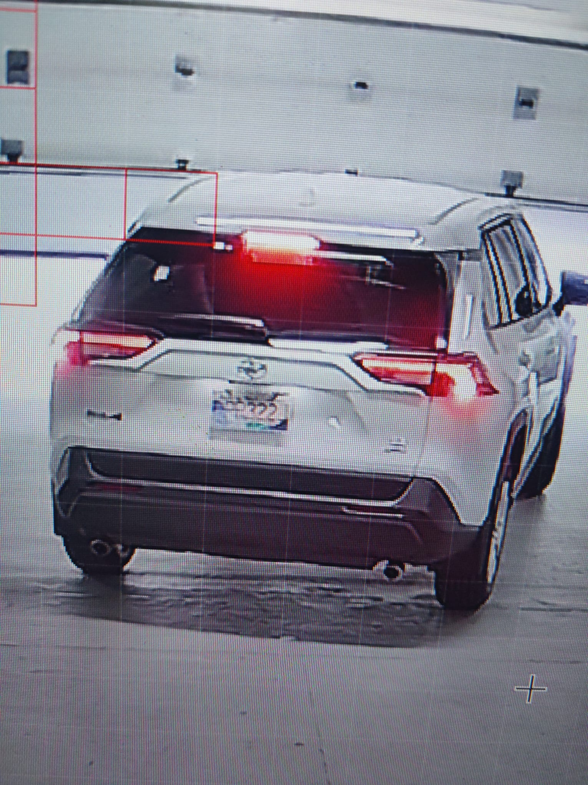 A white Toyota RAV4 caught leaving a parking garage.
