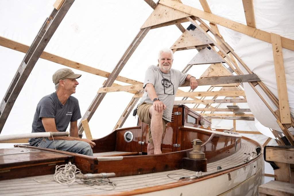 Shipwrights work at the Big Boat Shed where traditional wooden boats are built on the historic waterfront of Lunenburg, N.S., on Monday, July 7, 2025. Located on the Smith and Rhuland boatyard which opened in 1900, the workshop was the main boatbuilding facility where more than 270 boats were built — including the Bluenose II. THE CANADIAN PRESS/Darren Calabrese.