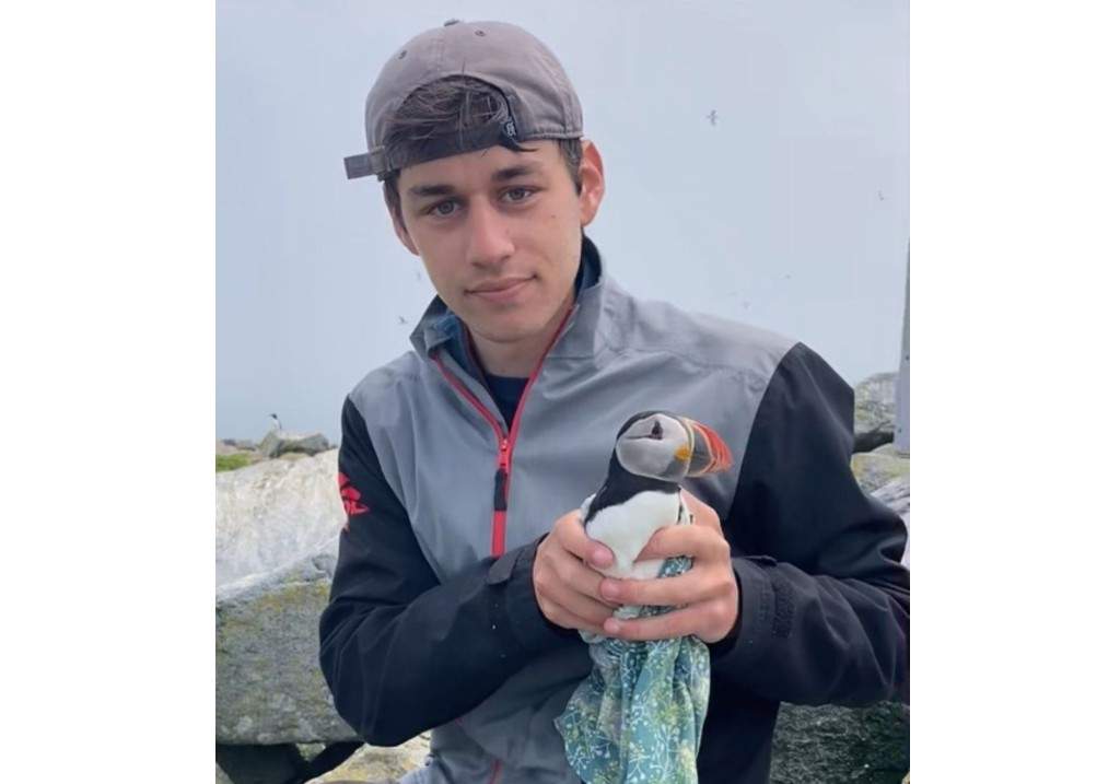Daniel Oliker, a University of New Brunswick graduate student on Machias Seal Island, N.B., is seen in this undated handout photo holding a puffin.