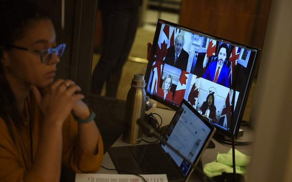 An interpreter works during a news conference in Ottawa on Saturday, Nov. 21, 2020. 