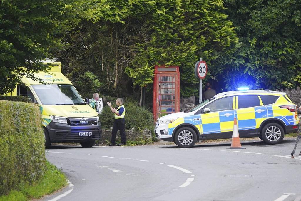 Emergency services operate near the scene of a school bus crash between Wheddon Cross and Timbercombe, near Minehead, England, Thursday, July 17, 2025. (Ben Birchall/PA via AP).