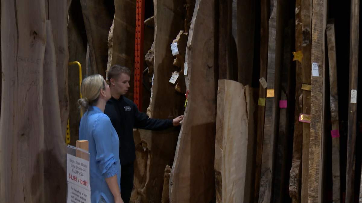 The General Manager of Black Forest Wood, Dylan Thomas, shows of some of the many unique pieces of wood the company sources from around the world to make its tables, doors and other pieces of furniture.