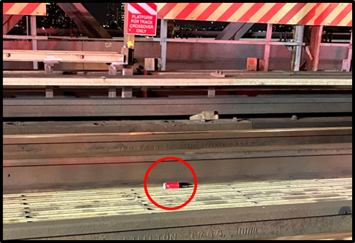 A red circle indicates what U.S. prosecutors say is an improvised explosive device allegedly manufactured by and thrown onto the subway tracks of the Williamsburg Bridge by Michael Gann in Manhattan on June 4, 2025.