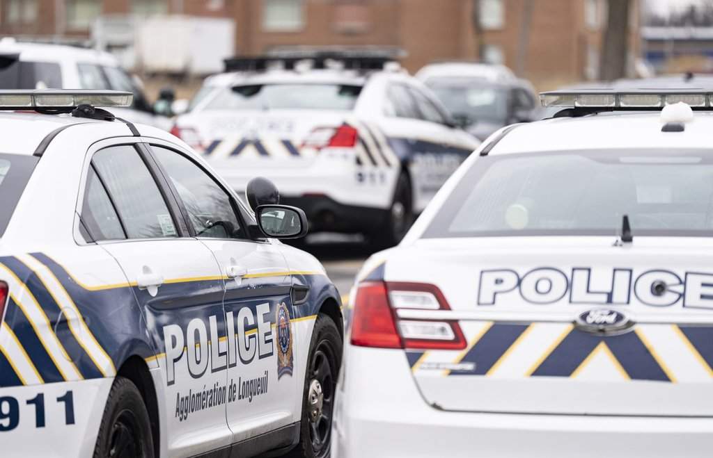 Longueuil police vehicles are parked in Longueuil, Que. Monday, March 4, 2024.