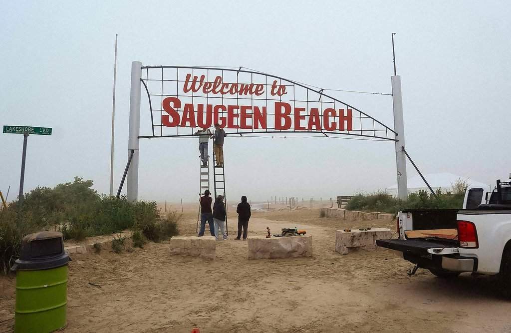 Saugeen First Nation members work on changing the lettering of the former Sauble Beach welcome sign, updated to reflect the reallocation of the land to the First Nations community, on Tuesday, July 1, 2025. THE CANADIAN PRESS/Handout -  Cheree Urscheler (Mandatory Credit).