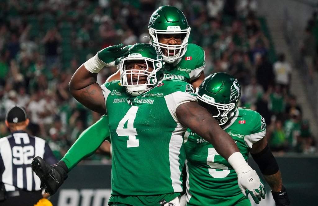 Saskatchewan Roughriders defensive lineman Micah Johnson (4) celebrates with teammates during the second half of CFL football action in Regina, on Friday, July 25, 2025. THE CANADIAN PRESS/Heywood Yu.