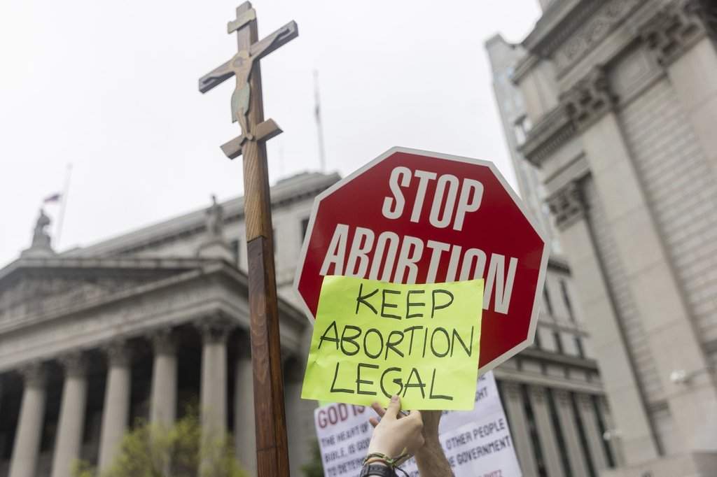FILE - Protesters hold competing signs outside Manhattan federal court during an abortion-rights demonstration in New York, May 14, 2022.  