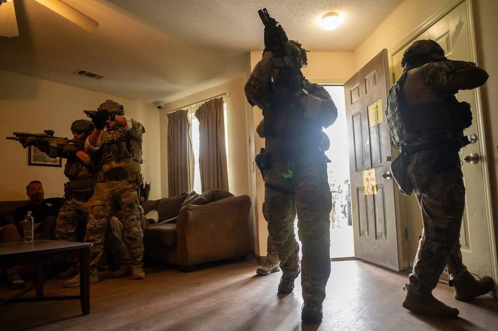 Immigration and Customs Enforcement (ICE) Special Response Team members demonstrate how the team enters a residence in the pursuit of a wanted subject at the Federal Law Enforcement Training Centers (FLETC) in Brunswick, Ga. on Thursday, Aug. 21, 2025.