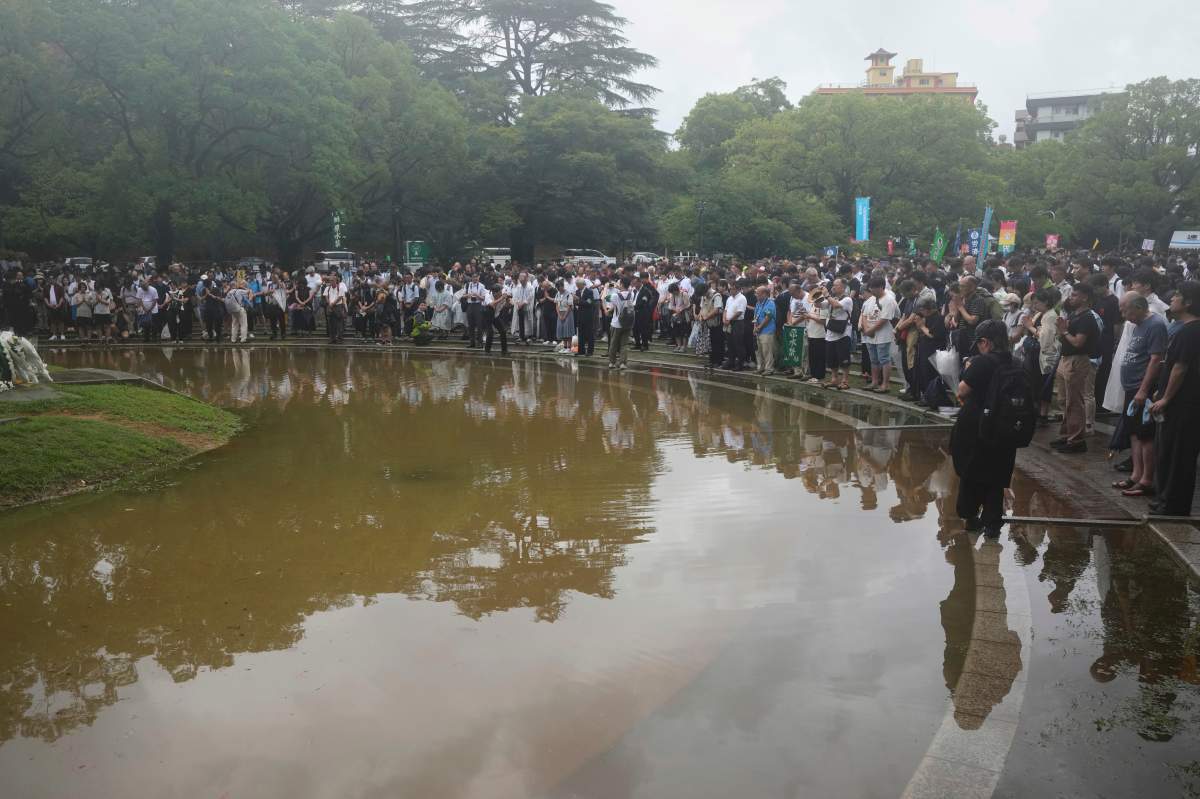 People observe a minute of silence at the Atomic Bomb Hypocenter Park, during a ceremony to commemorate the 80th anniversary of the day an atomic bomb was dropped on Japanese southwestern city, in Nagasaki, Japan Saturday, Aug. 9, 2025.