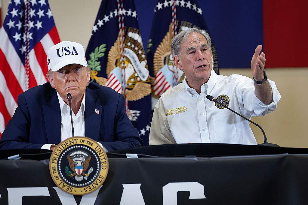 President Donald Trump and Texas Governor Greg Abbott participate in a round table event at the Hill Country Youth Event Center to discuss last week's flash flooding on July 11, 2025 in Kerrville, Texas.