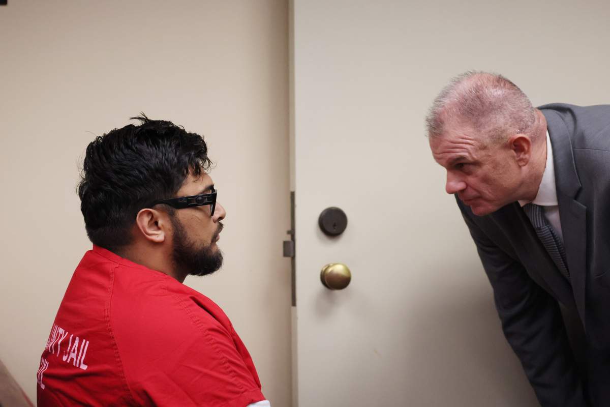 Jake Haro speaks public defender Brian Cosgrove during his arraignment on Tuesday, Aug. 26 at the Riverside Hall of Justice. Haro and his wife, Rebecca, were arrested Friday on suspicion of killing their son, Emmanuel Haro, who is 7 months old.