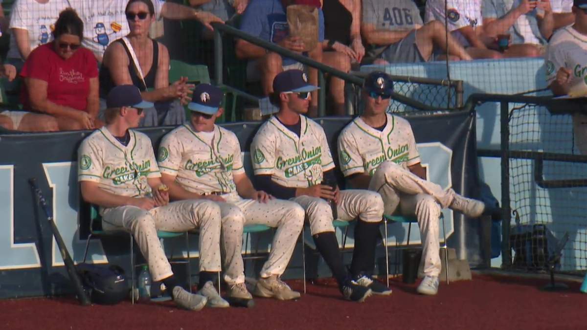 The Edmonton Riverhawks baseball players wearing their 2025 alternate identity jersey: the Green Onion Cakes.