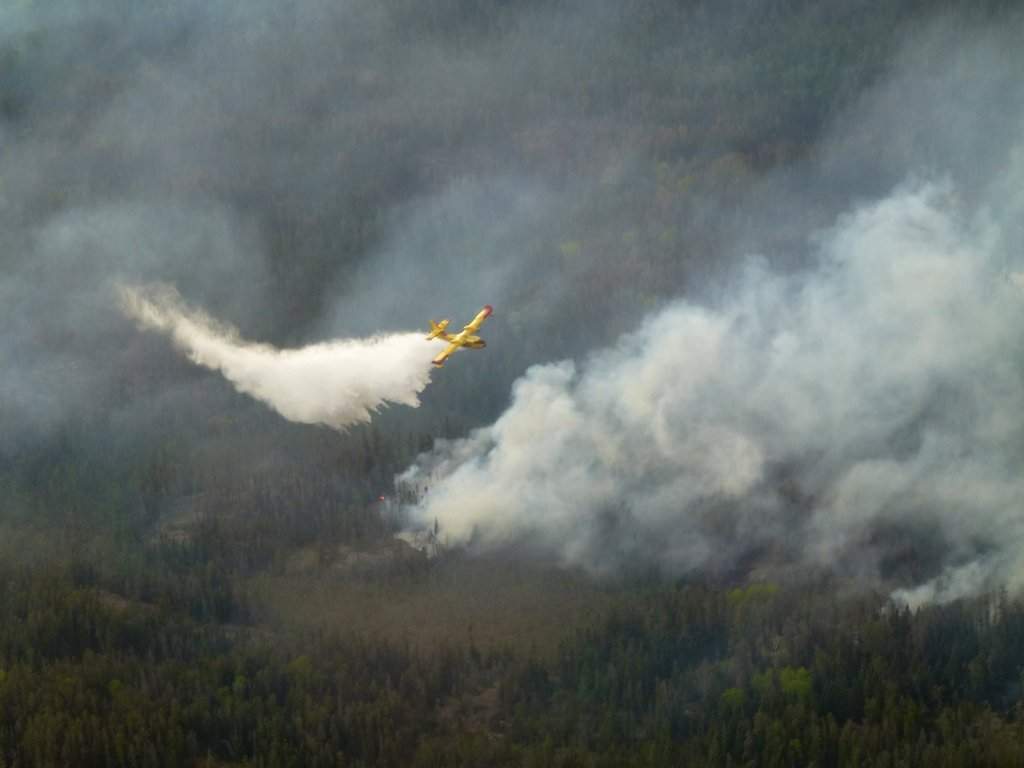 A water bomber aircraft battles a wildfire in southeast Manitoba as shown in this handout photo provided by the Manitoba government.