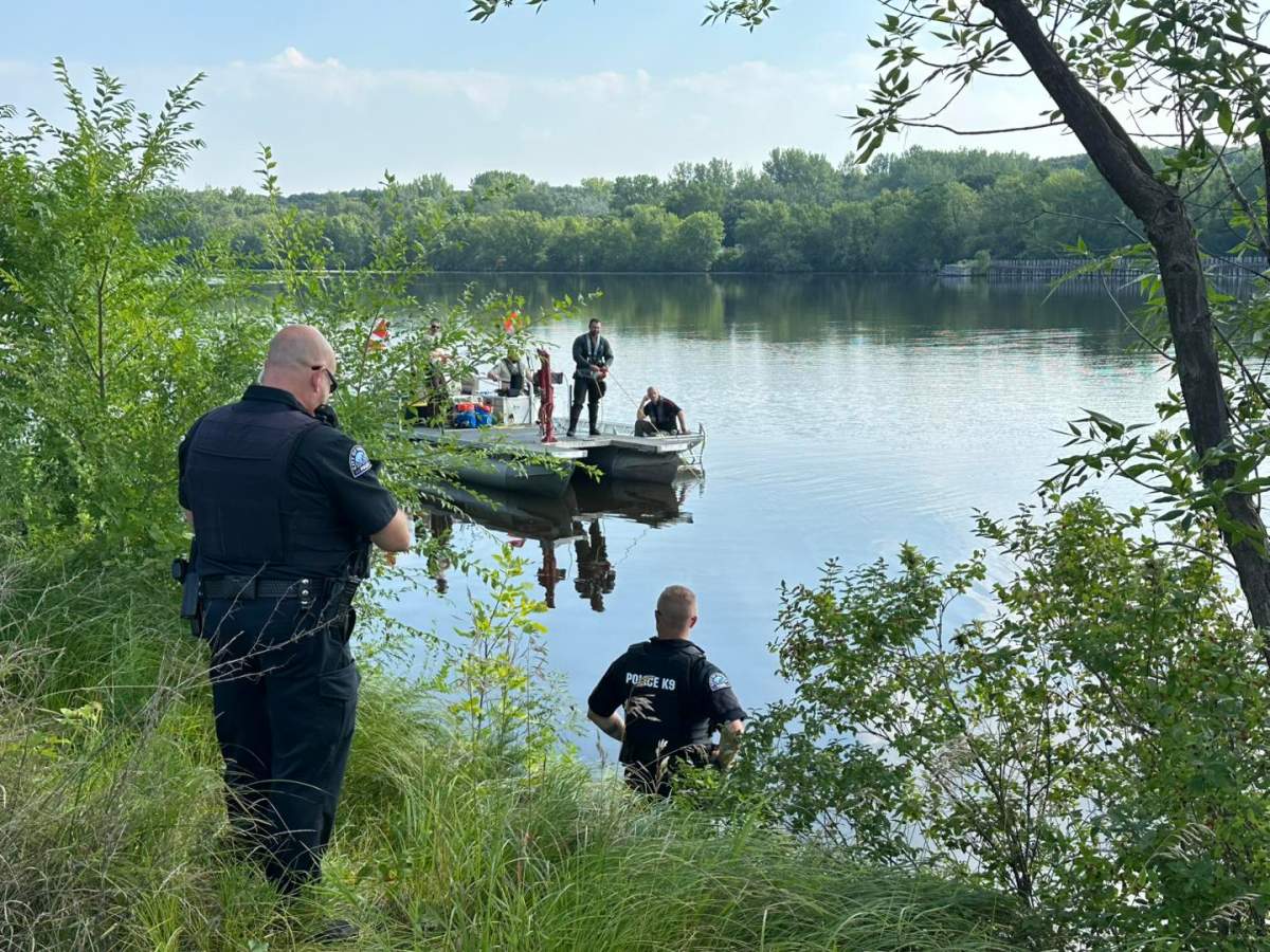 Officers from the Stearns County Sheriff's Office work to recovery the vehicle from the Mississippi River.