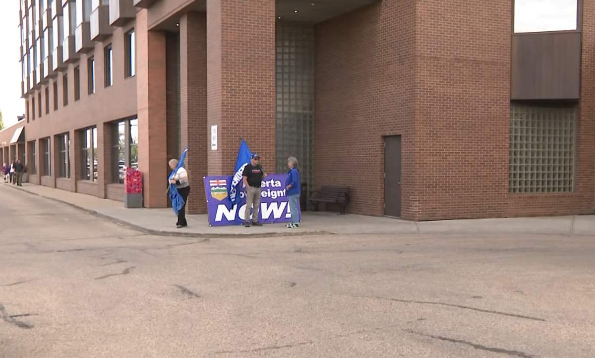 Several supporters of the idea of Alberta separation gather outside the town hall hosted by the Alberta Next panel in Edmonton in August.