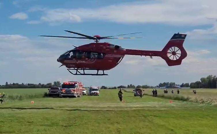 A STARS Air Ambulance helicopter lifts off from a grass airstrip in Linden, Ab. after being called in Tuesday to help transport a person to hospital in Calgary after they were seriously injured in a small plane crash.