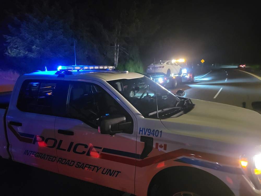 Two vehicles are towed, while a BC Highway Patrol- Integrated Road Safety Unit supervises, after their drivers failed Mandatory Alcohol Screening on Vancouver Island.
