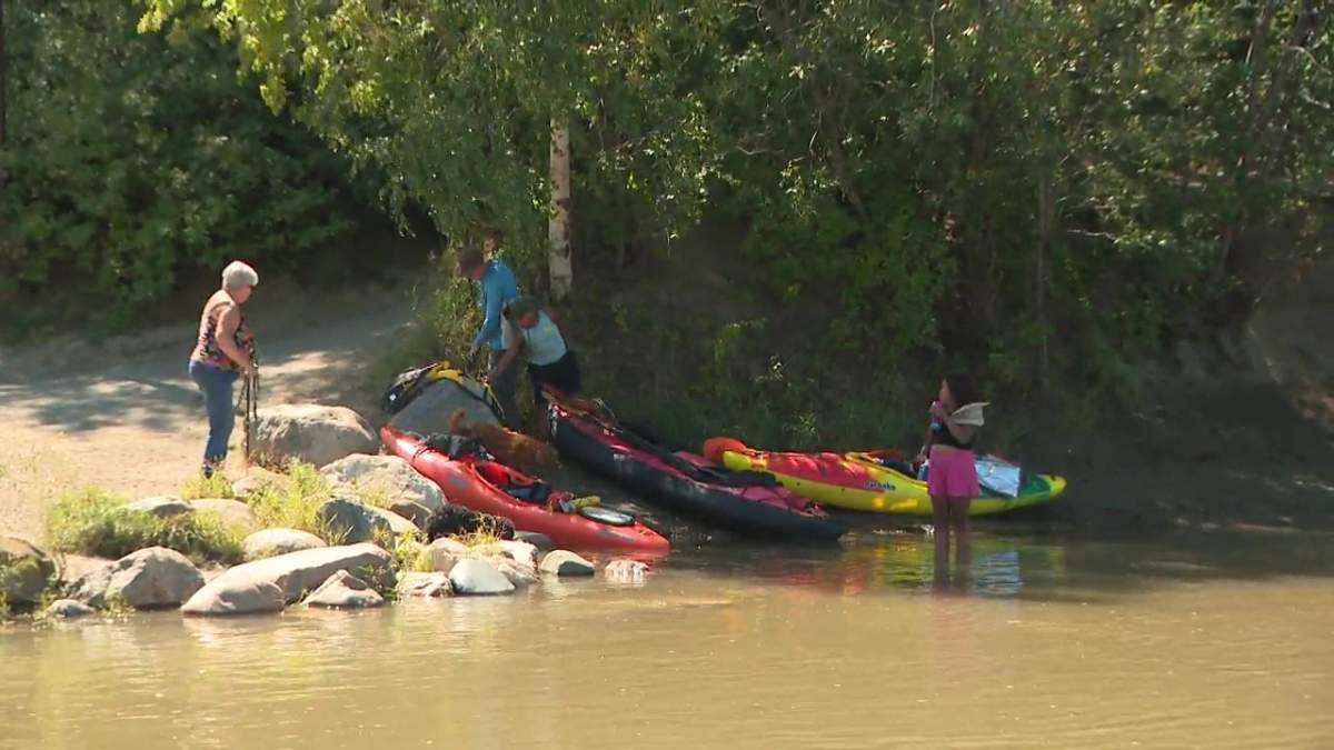 Kayakers wearing their life jackets at the Capilano boat launch on the North Saskatchewan River on July 31, 2025.
