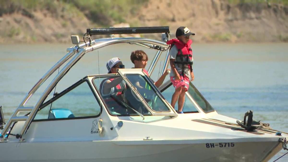Boaters wearing their life-jackets at the Capilano boat launch on the North Saskatchewan River on July 31, 2025.