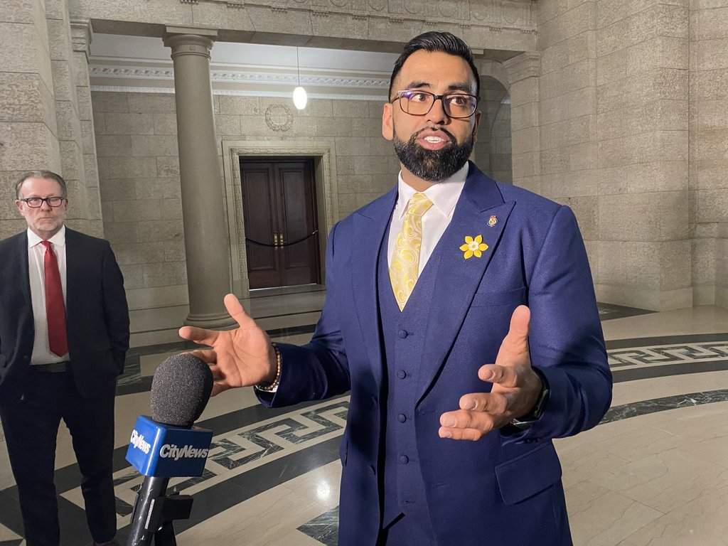Obby Khan speaks to reporters after being sworn-in as a member of the Manitoba legislature in Winnipeg, Monday, April 4, 2022.