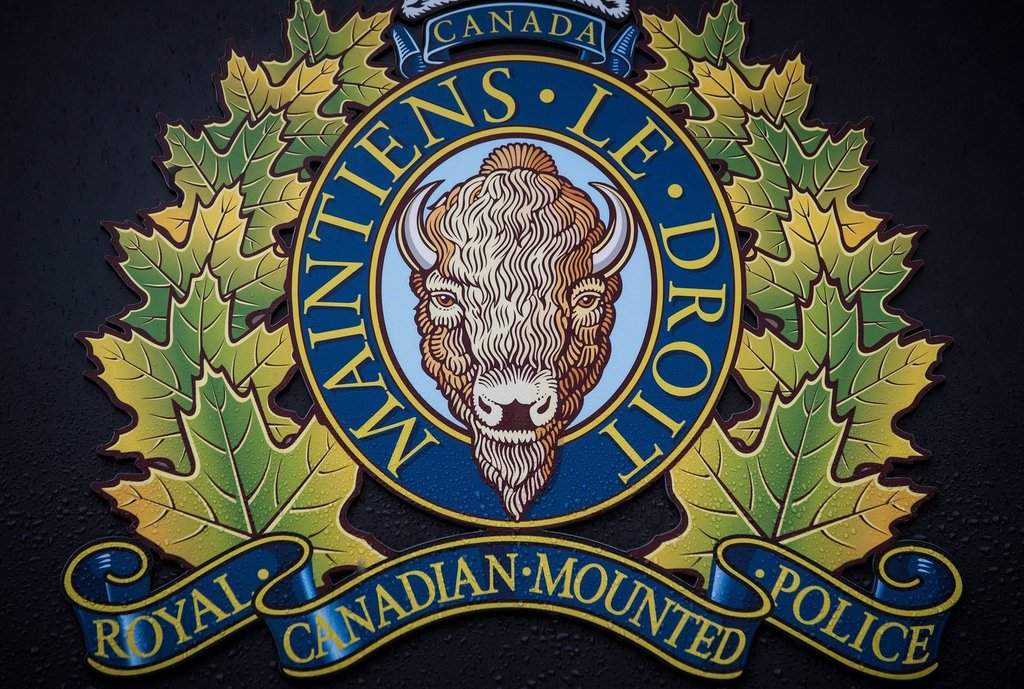 The RCMP logo is seen outside Royal Canadian Mounted Police "E" Division Headquarters, in Surrey, B.C., Friday, April 13, 2018. THE CANADIAN PRESS/Darryl Dyck.