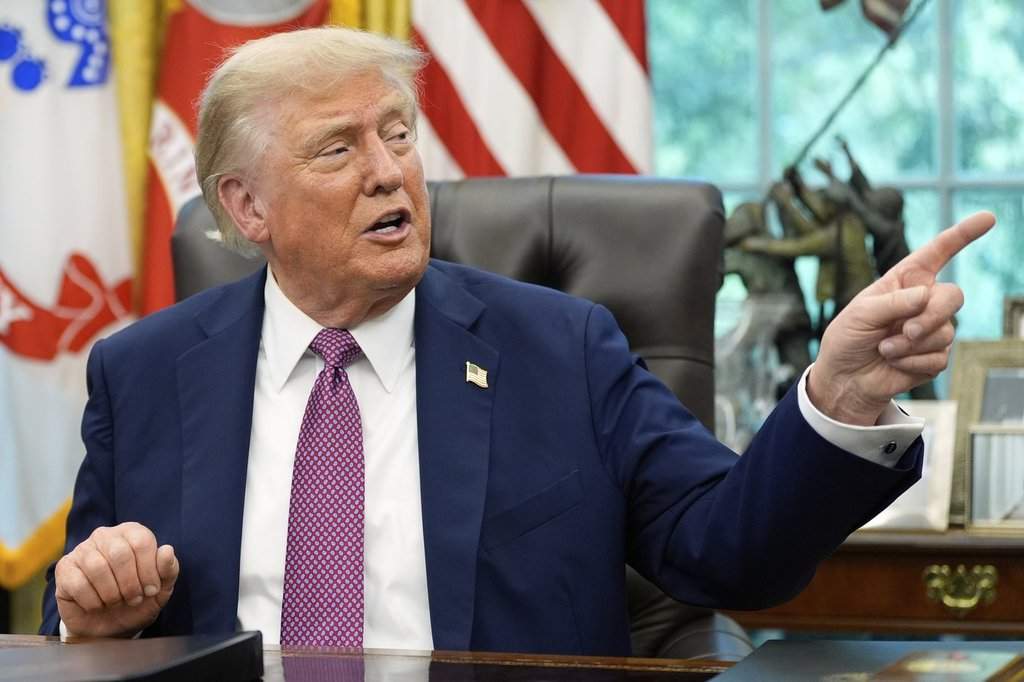 President Donald Trump point to a G20 Miami 2026 poster as he speaks in the Oval Office of the White House, Friday, Sept. 5, 2025, in Washington.
