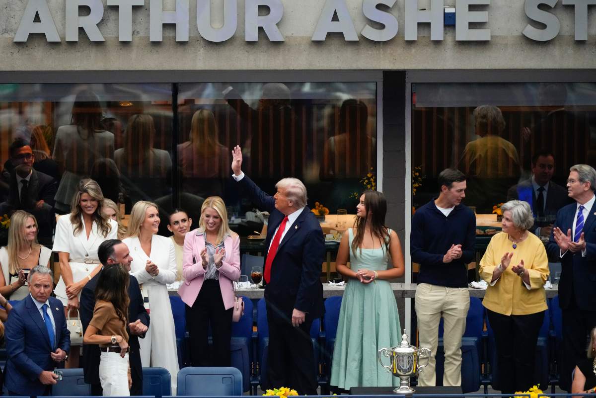 U.S. President Donald Trump waves to the crowd before the start of the men's singles final between Carlos Alcaraz, of Spain, and Jannik Sinner, of Italy, at the U.S. Open tennis championships, Sunday, Sept. 7, in New York.