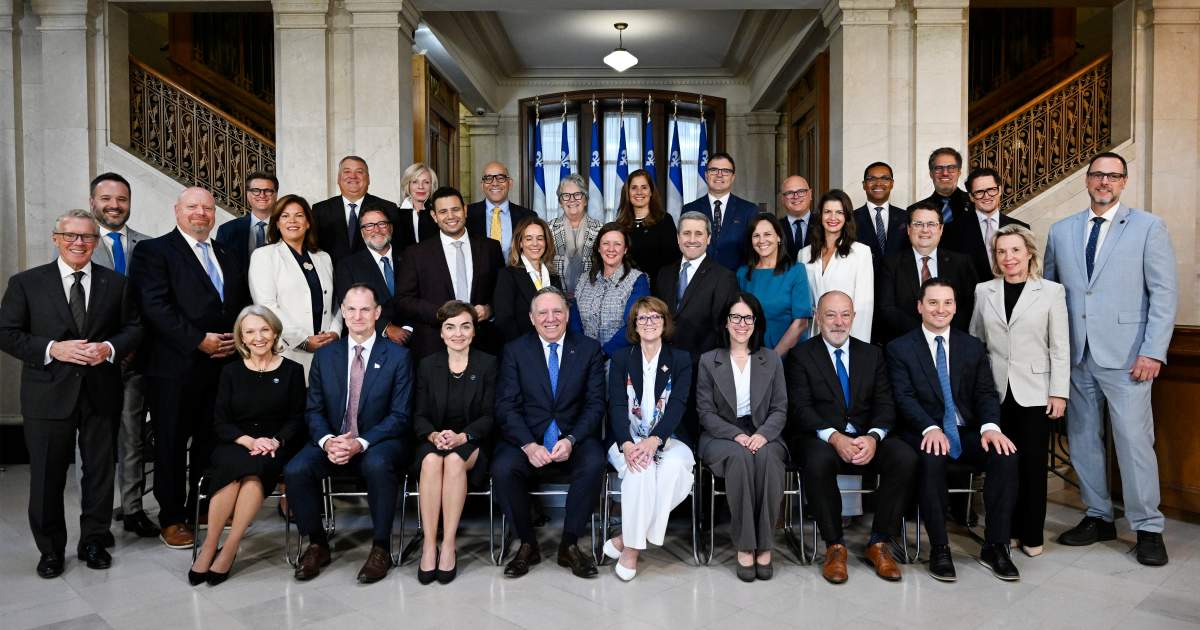 Quebec Premier Francois Legault, centre poses for a picture with his new cabinet in Quebec City, Wednesday, Sept. 10, 2025. From left, first row sitting, Sonia Belanger, Eric Girard, Christine Frechette, Francois Legault, Lt. Gov. Manon Jeannotte, Sonia Lebel, Christian Dube, Simon Jolin-Barrette; second row; Jean Boulet, Ian Lafreniere, Kateri Champagne Jourdain, Donald Martel, Samuel Poulin, France-Elaine Duranceau, Amelie Dionne, Jean-Francois Simard, Isabelle Charest, Genevieve Guilbault, Bernard Drainville, Martine Biron, Jean-Francois Roberge; third row, Mathieu Lacombe, caucus president Yves Montigny, government whip Francois Jacques, Caroline Proulx, Christopher Skeete, Chantal Rouleau, Pascale Dery, Jonathan Julien, Lionel Carmant, Gilles Belanger and Benoit Charette. THE CANADIAN PRESS/Jacques Boissinot
