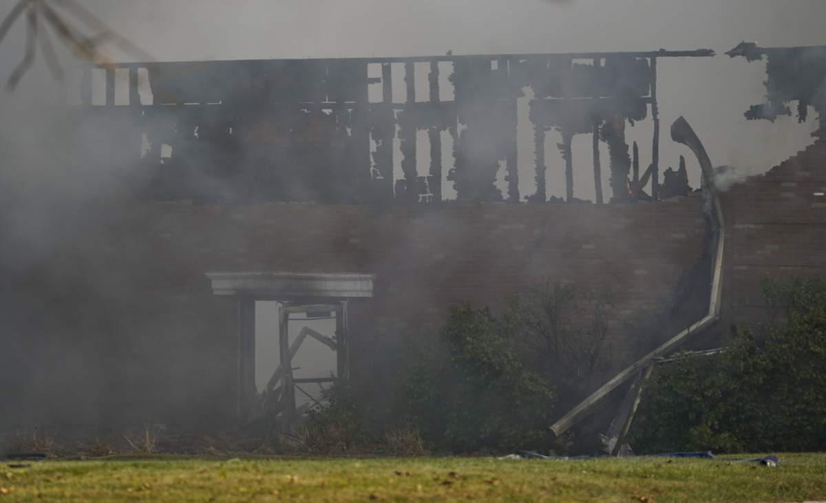 Smoke surrounds the building of the Church of Jesus Christ of Latter-day Saints in Grand Blanc on Sunday, Sept. 28, 2025 after active shooter and fire was reported at the church.
