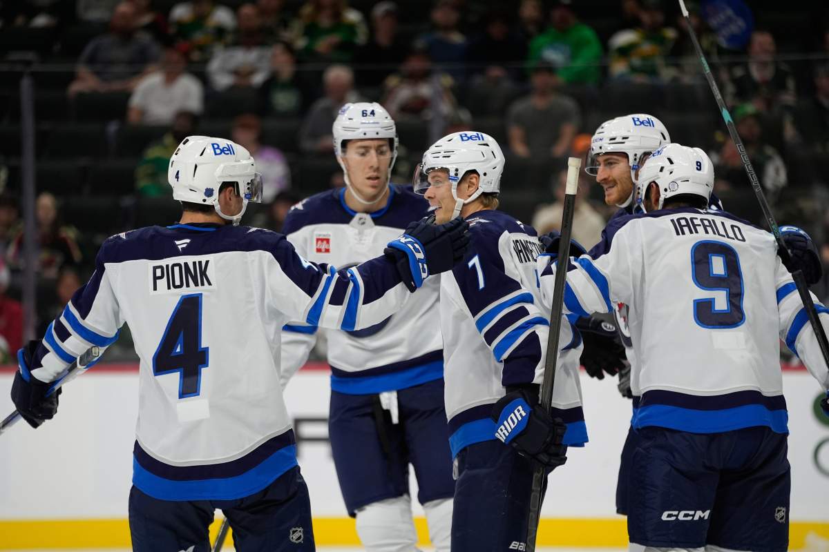 Winnipeg Jets center Vladislav Namestnikov (7) celebrates with teammates after scoring a goal during the second period of an NHL hockey preseason game against the Minnesota Wild, Tuesday, Sept. 30, 2025, in St. Paul, Minn.