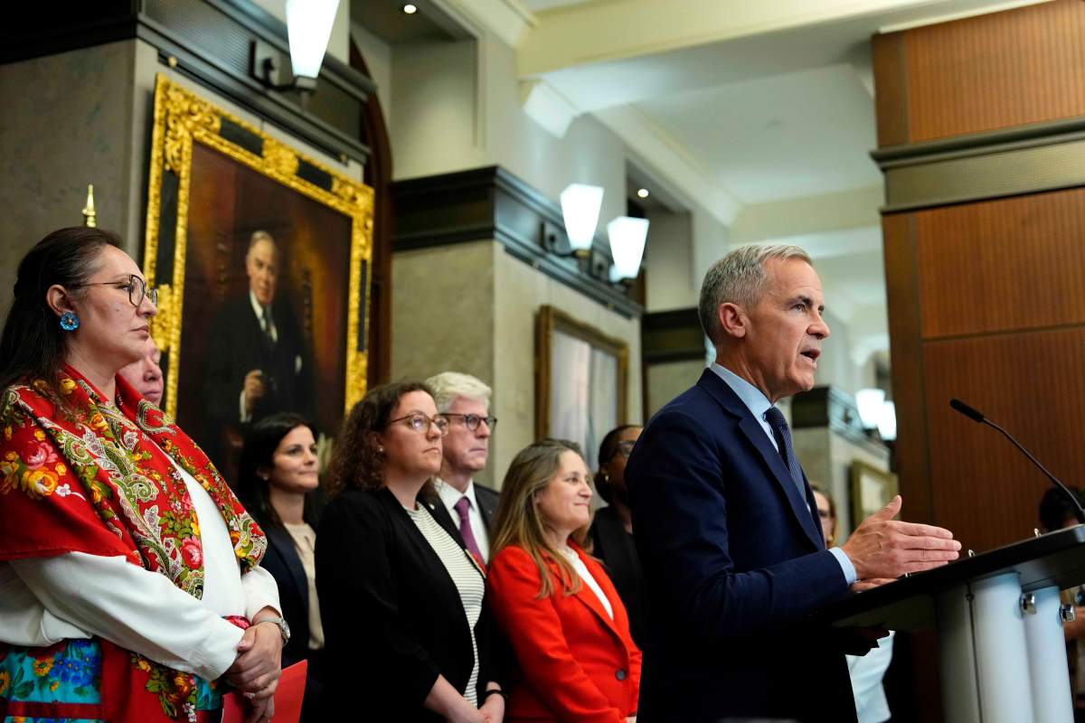 Prime Minister Mark Carney is joined by members of his cabinet and caucus as he speaks at a news conference in the Foyer of the House of Commons in Ottawa, after Bill C-5 passed in the House, on Friday, June 20, 2025.