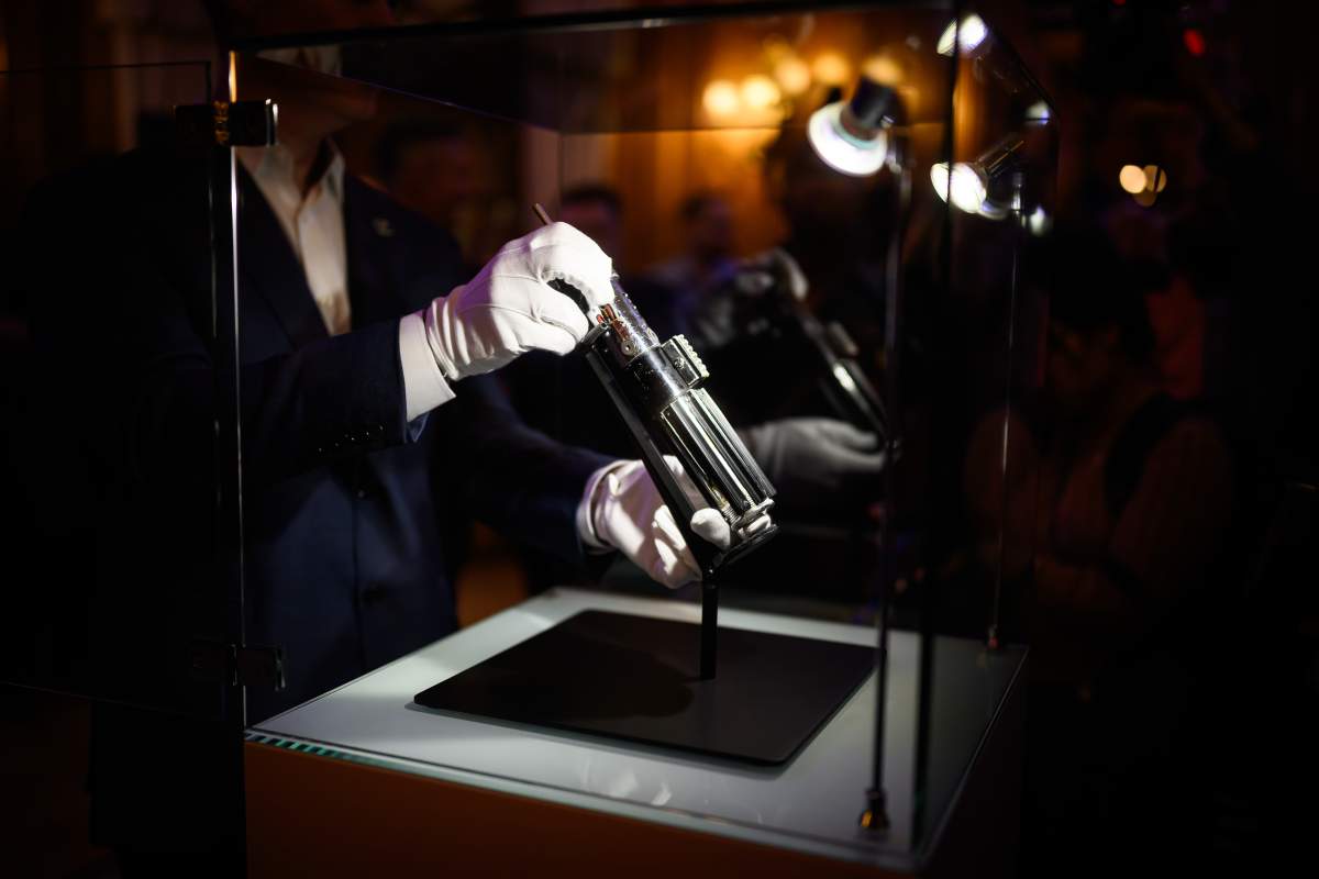 The screen-matched lightsaber prop, used by the character 'Darth Vader' in the Star Wars films 'The Empire Strikes Back' and 'Return Of The Jedi,' is displayed at a photocall ahead of an auction of entertainment memorabilia by Propstore, on August 6, 2025 in London, England.