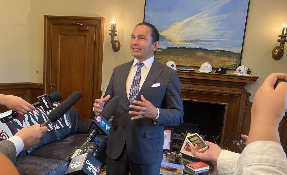 Premier Wab Kinew speaks to media from the Manitoba legislature.