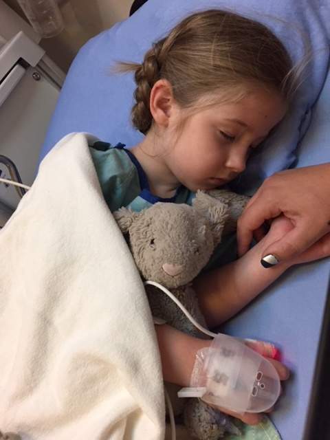 A young girl in a hospital bed