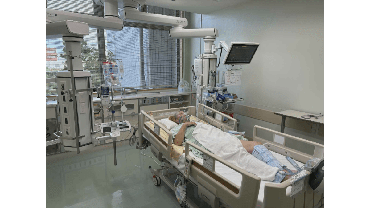 A photo of Dione Amundson as she lays in a hospital be in Japan after suffering a perforated intestine.