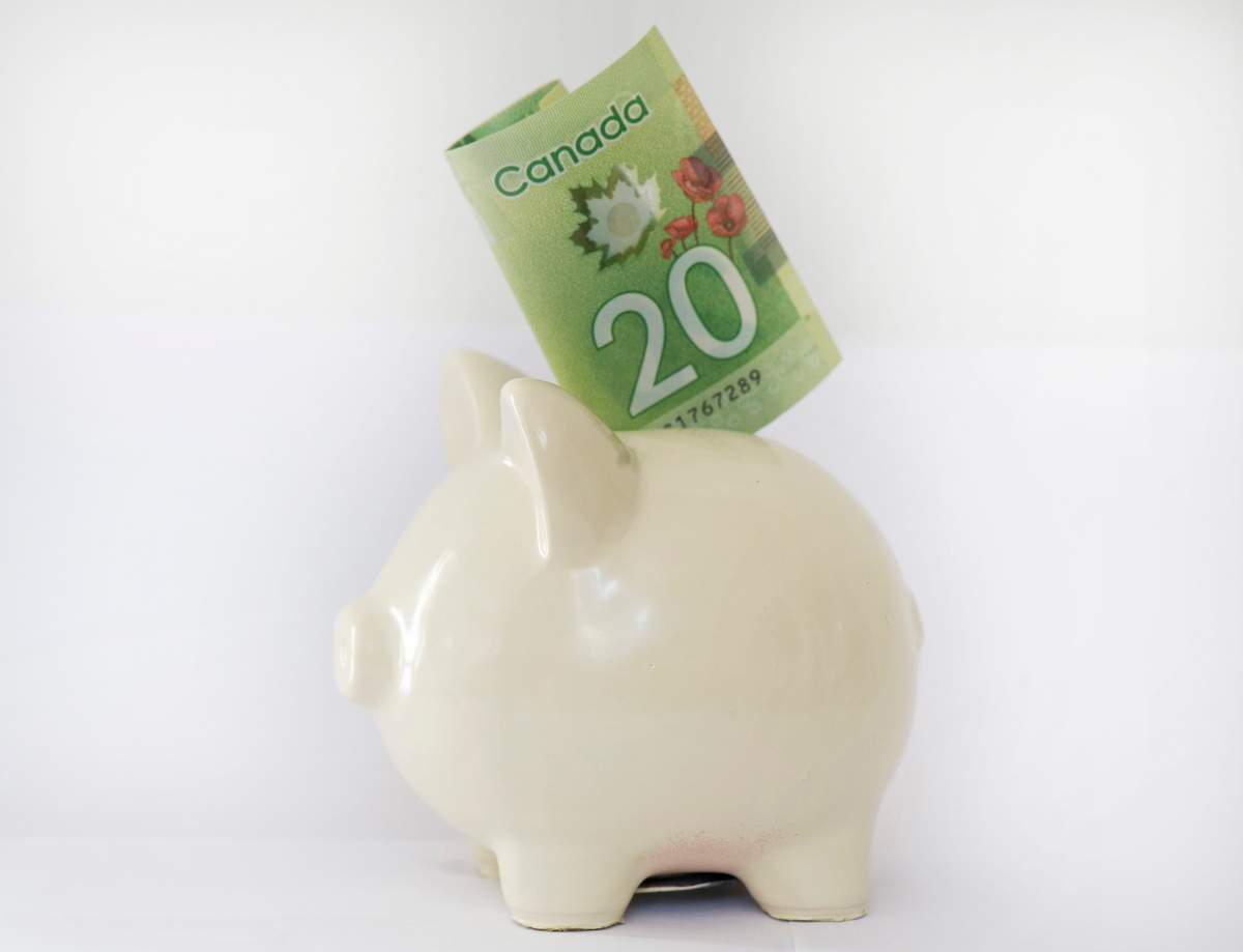 A piggy bank with a $20 bill is shown in Montreal, Monday, Dec. 16, 2013.