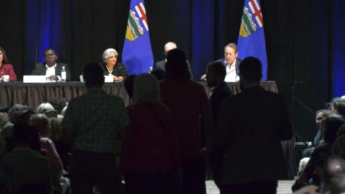 A high school student who attempted to question panel members about the provincial government's dispute with teachers, had his mic abruptly cut off as moderator Bruce McAllister suggested the students parents should "turn you over their knee."