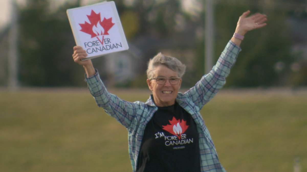 One of a smattering of protestors who gathered outside Danielle Smith's Alberta Next town hall in Calgary on Monday evening, the last one on the province wide tour.