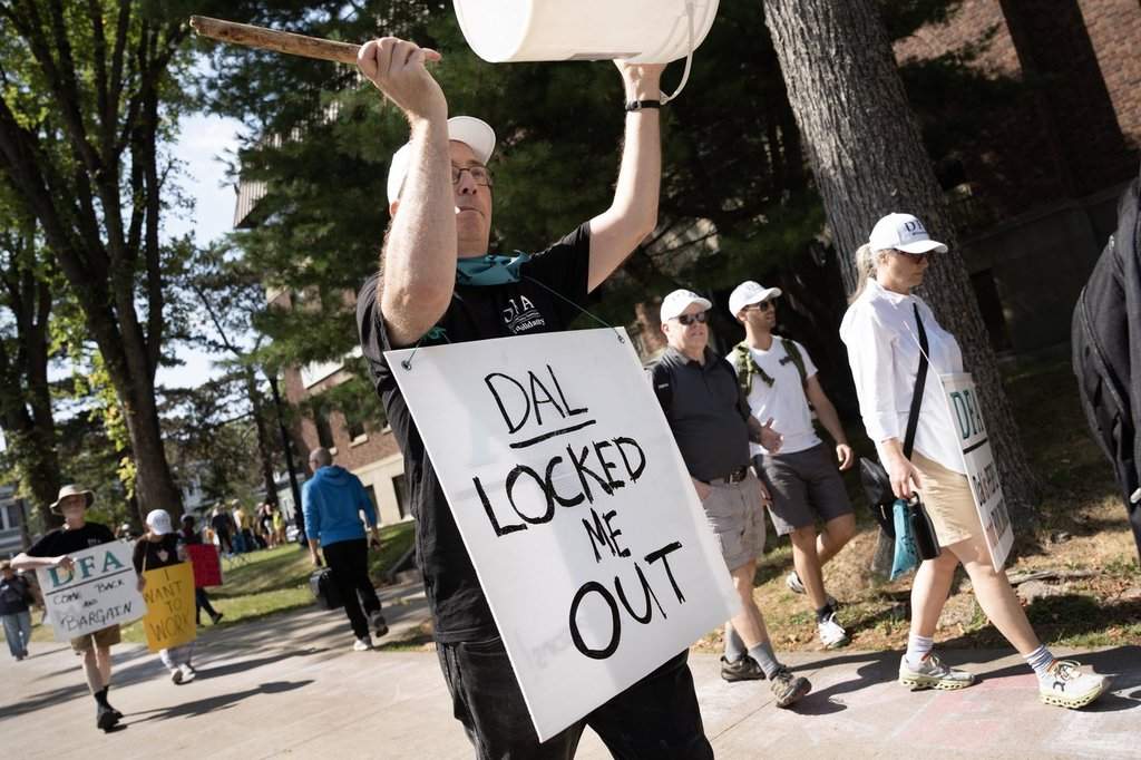 Members of the Dalhousie Faculty Association walk a picket line as students arrive on campus to begin the school year at Dalhousie University in Halifax, Tuesday, Sept. 2, 2025. The first day of school was cancelled for most Dalhousie University students after the university locked members out over a contract dispute. THE CANADIAN PRESS/Darren Calabrese.