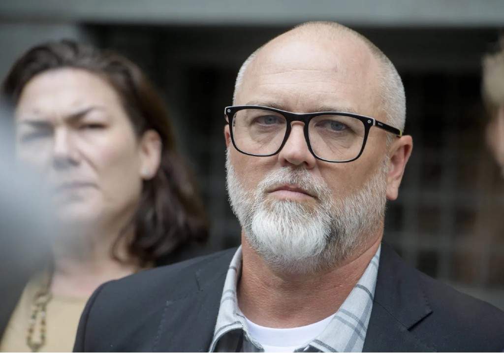 Jan Carey, a North Carolina veteran who burned a flag near the White House last month, listens while his lawyers speak following his arraignment at the E. Barrett Prettyman Federal Courthouse, Sept. 17, 2025 in Washington.